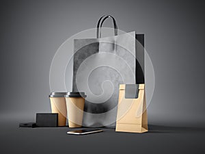 Set of black shopping bag, coffee cups, paper package, blank business cards and generic design smartphone. Dark