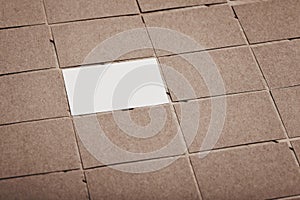 Set of blank business cards are on a wooden table and laid out next to each other. White card in the center.