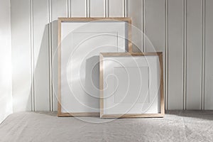 Set of blank vertical and square wooden picture frame mock ups in sunlight. White beadboard wainscot wall paneling