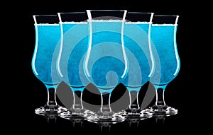 Set of blue curacao cocktails in hurricane glass isolated on black background