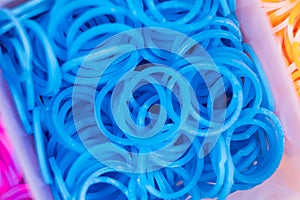 A set of blue elastic bands for weaving bracelets for children.