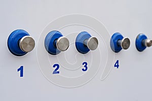 Set of Blue and Silver Knobs on White Wall