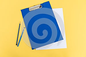 A set of blue stationery as a template with a place to copy on a yellow background, pen and pencil