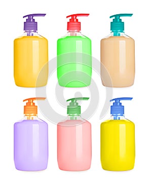 Set with bottles of multicolored liquid soap on white background