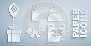 Set Bow tie, Winter hat, Gift box, Calendar, Burning candle and Balloons with snowflake icon. Vector