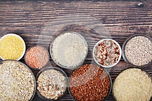 A set of bowls filled with different seeds: buckwheat, rise, corn and oatmeal