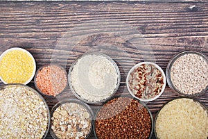 A set of bowls filled with different seeds: buckwheat, rise, corn and oatmeal