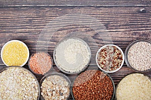 A set of bowls filled with different seeds: buckwheat, rise, corn and oatmeal