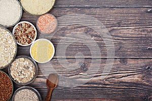 A set of bowls filled with different seeds: buckwheat, rise, corn and oatmeal