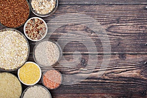 A set of bowls filled with different seeds: buckwheat, rise, corn and oatmeal