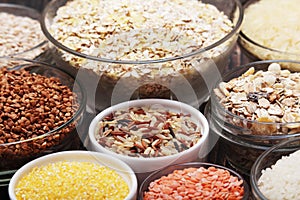 A set of bowls filled with different seeds: buckwheat, rise, corn and oatmeal
