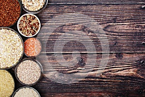 A set of bowls filled with different seeds: buckwheat, rise, corn and oatmeal