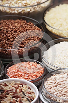 A set of bowls filled with different seeds: buckwheat, rise, corn and oatmeal