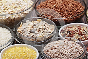 A set of bowls filled with different seeds: buckwheat, rise, corn and oatmeal