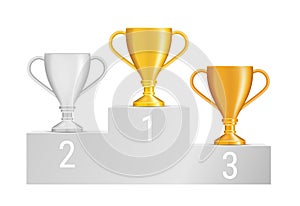 Set of bronze, silver and gold trophies on grey podium isolated