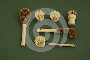 Set of brushes for eco-cleaning the home, washing dishes and surfaces without chemicals on a green surface. Zero waste