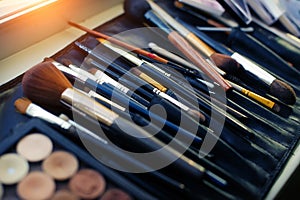 Set of brushes for professional makeup in special black case, close-up. A variety of brushes and applicators, make-up artist tool