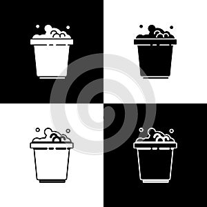 Set Bucket with soap suds icon isolated on black and white background. Bowl with water. Washing clothes, cleaning