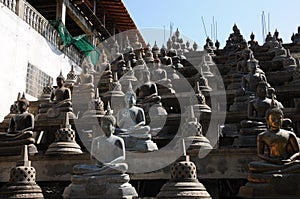 Set of Buddha statues and small stupas in Gangaramaya temple,