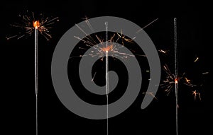Set of burning sparklers on black background