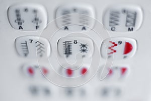 A set of buttons to select the type of stitching on the sewing machine. Sewing industry