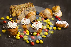 Set of cakes on a dark background.