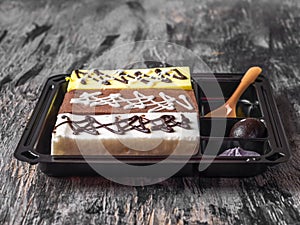 A set of cakes with different patterns in a dark container