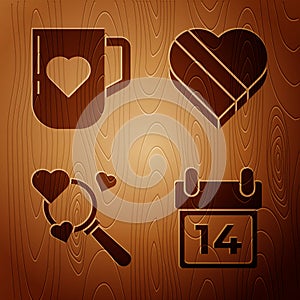 Set Calendar with February 14, Coffee cup and heart, Search heart and love and Candy in heart shaped box on wooden