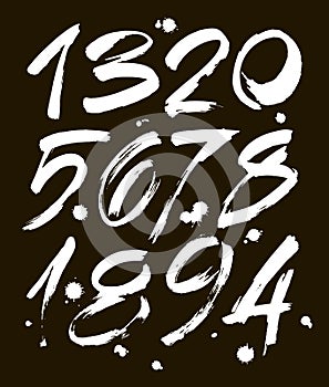 Set of calligraphic acrylic or ink numbers. ABC for your design, brush lettering on a black background with blots