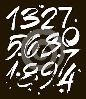 Set of calligraphic acrylic or ink numbers. ABC for your design, brush lettering on a black background with blots