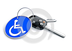 Set of car keys with keyring and a wheelchair icon on it. Concept for assisted driving and issues endured by handicapped persons photo