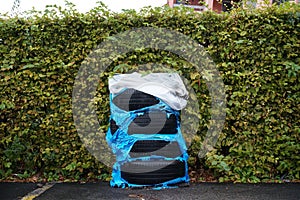 A set of car tyres left or stored on the parking lot close up or in detail