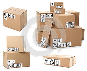 Set of cardboard boxes with packaging symbols on background