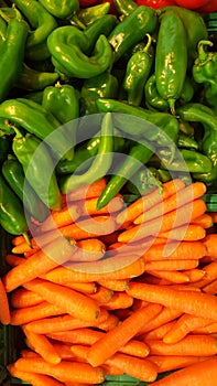 Set of carrots and green chillies. Group of vegetables displayed.