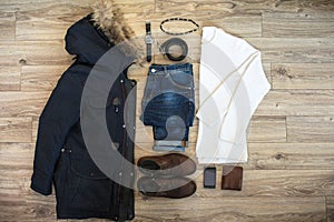 Set of casual winter men clothes and accessories on wooden background. Top view.