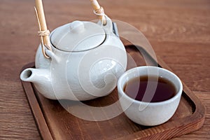 A set of ceramic japanese style teapot on wood serving tray