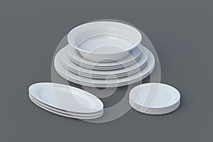 Set of ceramic plates on gray background