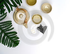 A set of ceramic teapot with wood handle on table