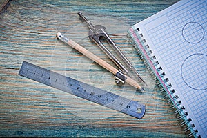 Set of checked copybook ruler pair of compasses pencil on vintag