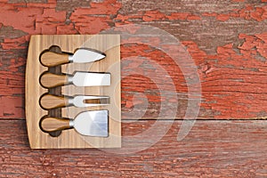 Set of cheese cutters in a fitted wooden block photo