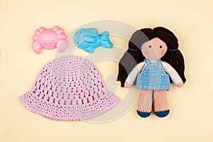 Set - children`s panama, toys for sand, amigurumi dolls with brown hair. The concept of vacations, games in kindergarten.