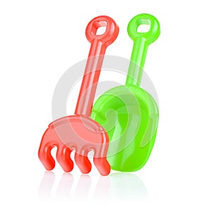 A set of children's toys for playing in the sandbox. Colored rake and shovel made of plastic, isolated on a