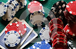 Set of chips and cards on a green baize gambling casino