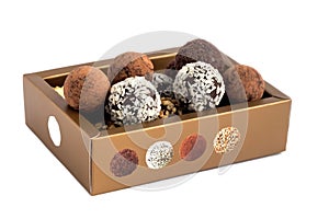 A set of chocolates with different sprinkles in a gift box.Isolated on a white background.