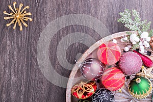 Set of Christmas decorations in wooden tray on grunge background. Holiday concept. Flat lay, top view