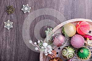 Set of Christmas decorations in wooden tray on grunge background. Holiday concept. Flat lay, top view