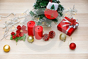 Set of Christmas decorative items red and gold shiny glossy sphere balls Candles Present gift box with silver ribbon bowtie Light