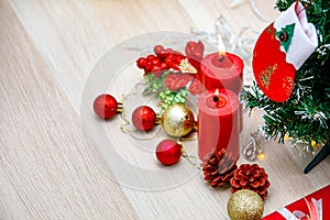 Set of Christmas decorative items red and gold shiny glossy sphere balls Candles Present gift box with silver ribbon bowtie Light