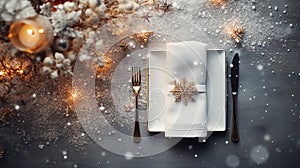 set of Christmas laid table, luxurious plates, silver cutlery, Christmas dinner or New Year\'s Eve party