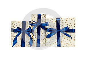 Set of Christmas or other holiday handmade present in gold paper with blue ribbon. Isolated on white background, top view.